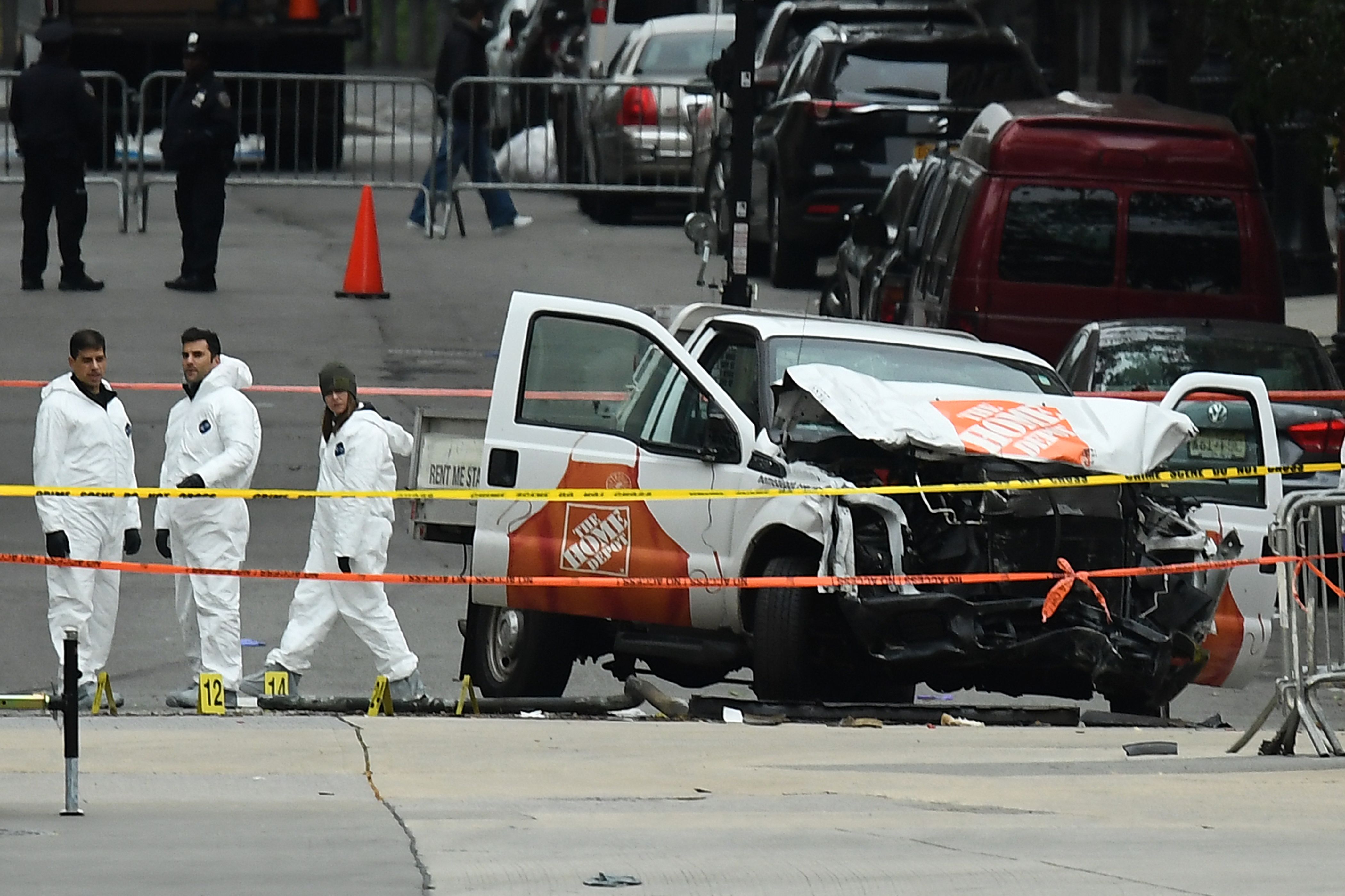 Investigators work around the wreckage of a Home Depot pickup truck a day after it was used in a terror attack in New York on November 1, 2017.
The pickup truck driver who plowed down a New York cycle path, killing eight people, in the city's worst attack since September 11, was associated with the Islamic State group but